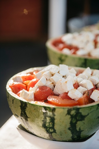 The watermelon bowls filled with a delightful combination of fresh tomatoes and creamy mozzarella