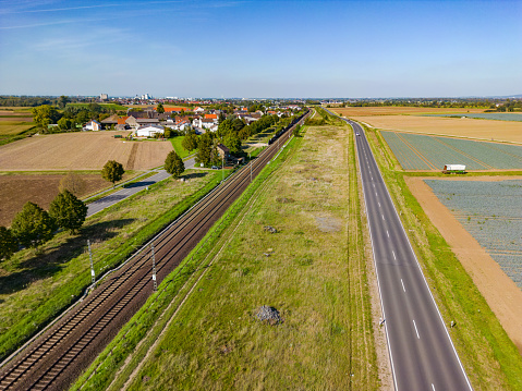 Drone perspective of rural road and railroad line in the countryside, aerial view in Germany