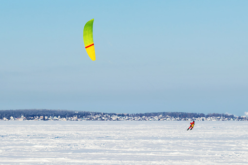 An athlete engages in winter kitesurfing under a colorful dome on snow-covered Lake Onega in the city of Petrozavodsk, Karelia on February 10, 2024.