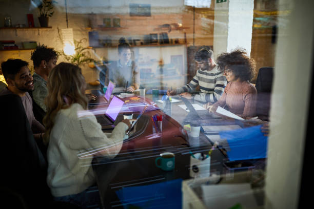 istock Happy multi-tasking freelancers working late in the office. 2012182940
