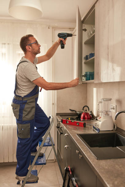 istock Handyman fixing kitchen cabinets in the apartment. 2012190303