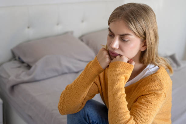 istock Depressed woman sitting on the bed feel lonely at home 2012193500