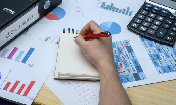 istock Settlement of company documents, accountant calculates profits 2012199461