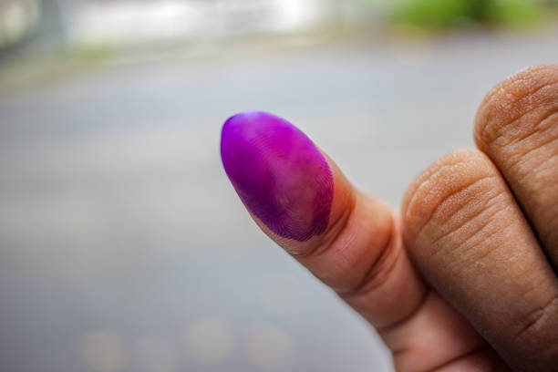 a picture of a man's hand. The ink on a man's finger was obtained after voting during the regional elections (pilkada) in Semarang, Indonesia
