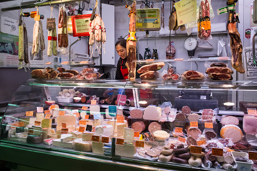 Horizontal view of a delicatessen stall in the old Abaceria Central Market of the Gracia neighborhood in Barcelona