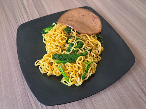 Fried Noodles Or Mi Goreng With Smoked Beef And Mustard Green On A Plate. Mie Goreng. Food Menu.