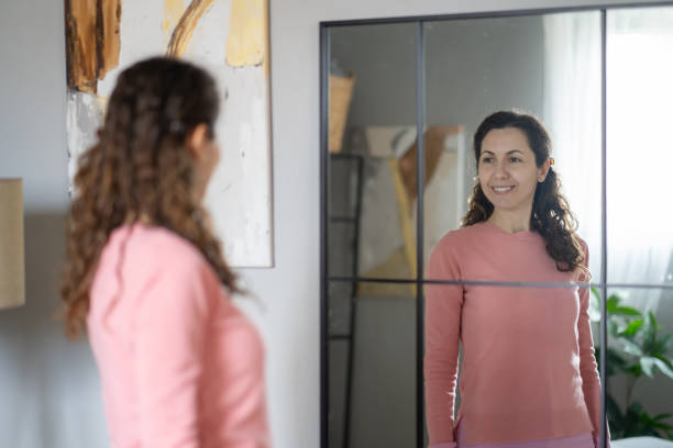 istock Woman is looking herself in the mirror 2012244515