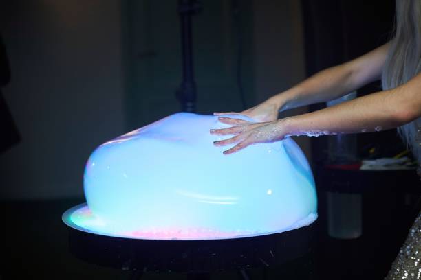 istock A show of illuminated soap bubbles. A woman's hand 2012247065