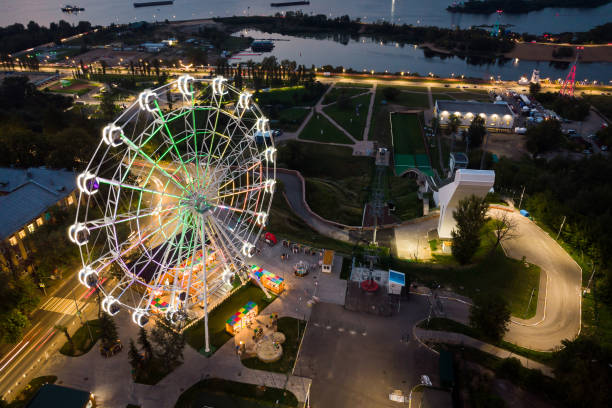istock Beautiful sunset over the city with a lighted Ferris wheel. 2012291609
