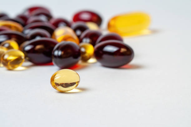 istock Various dietary supplement on a white surface, glossy pills scattered on a clean. 2012306568