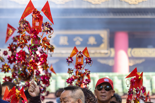 2024 Feb 11,Hong Kong.People holds a toy windmill for good luck at the Che Kung temple
