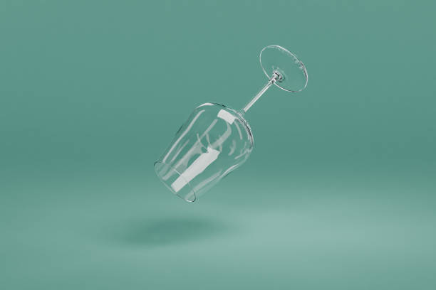 wine glass falling on clean surface isolated on infinite background; 3D rednering wine glass falling on surface isolated on infinite background; 3D rednering wine glass knocked over stock pictures, royalty-free photos & images