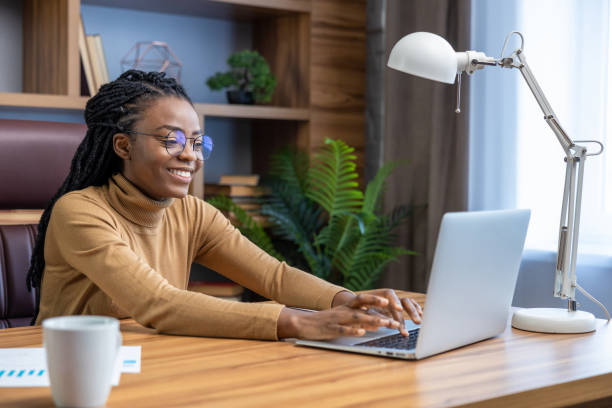 istock Professional in glasses with dreadlocks works online from home office 2012328080