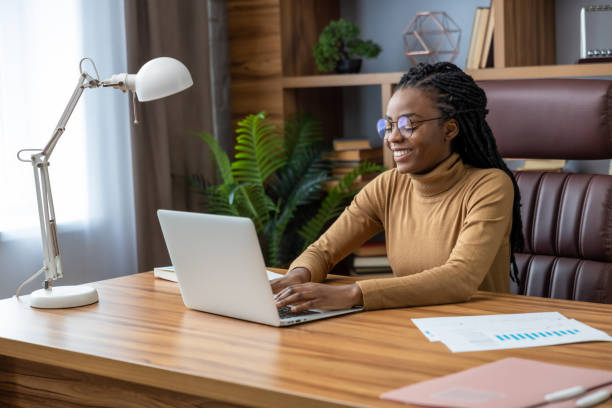 istock Confident worker with dreadlocks works remotely with laptop and technology 2012328095