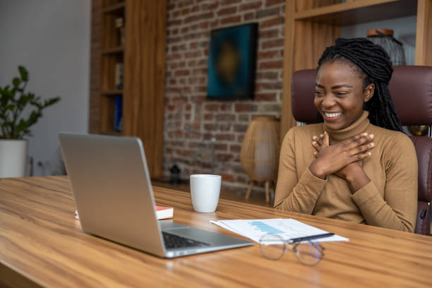 istock Cheerful woman with dreadlocks using laptop engages in virtual education conducting webinars 2012328141