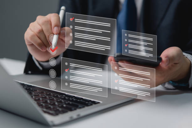 istock Businessman holding a digital checklist with checkboxes,assessment, questionnaire, evaluation, online survey online exam and organization. 2012345652