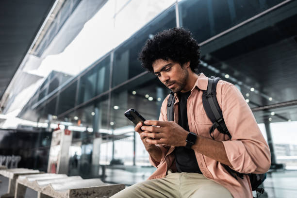 istock Mid adult man using mobile phone while wait at airport 2012346417