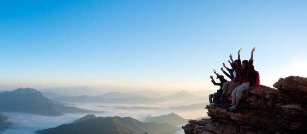 istock Group of happy hiker raised up arms on the hill 2012366475