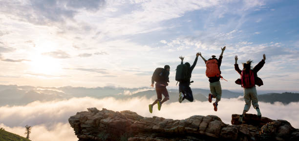 istock Group of happy hiker jumping on the hill 2012366688