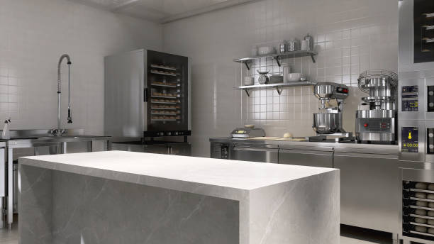 istock Empty clean white marble top counter table in commercial, professional bakery kitchen, stainless steel convection deck oven, kneading machine, shelf, cabinet 2012371606