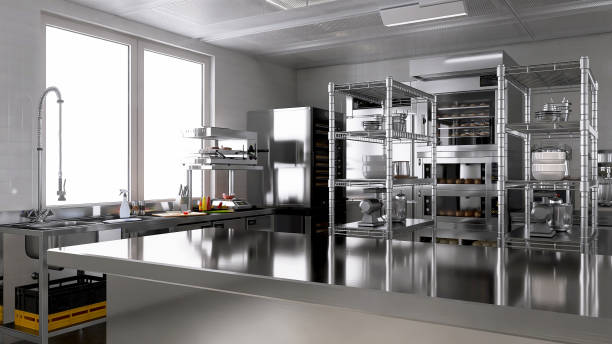 istock Empty clean stainless steel counter table in commercial, professional bakery kitchen with convection, deck oven, refrigerator, sink in sunlight 2012372141