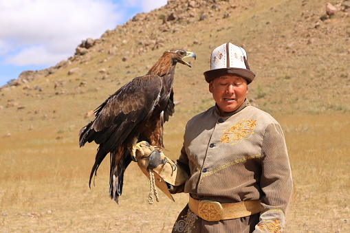 August 27 2023 - Bokonbayevo, Issyk Kul Province in Kyrgyzstan: a Kyrgyz Eagle Hunter with His Eagle