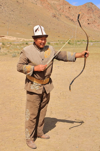 August 27 2023 - Bokonbayevo, Issyk Kul Province in Kyrgyzstan: a Kyrgyz Eagle Hunter preparing for archery
