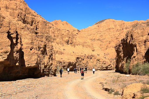 August 27 2023 - Aksai, Aksay in Kyrgyzstan: people enjoy the canyon formation at the Issyk Kul Lake