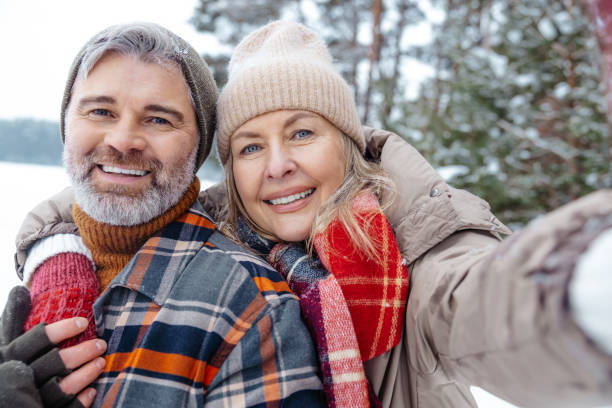 istock Mature couple looking happy and making selfie 2012386450
