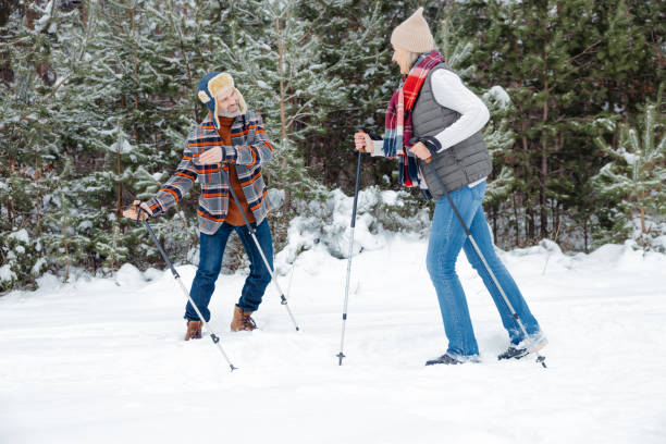 istock Couple on a walk with scandinavian sticks 2012386461