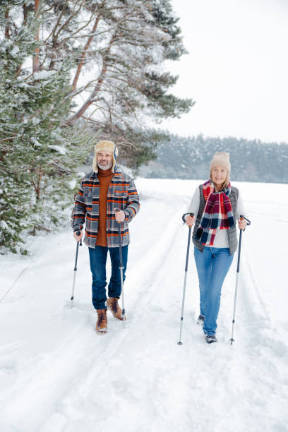 istock Couple on a walk with scandinavian sticks 2012386464