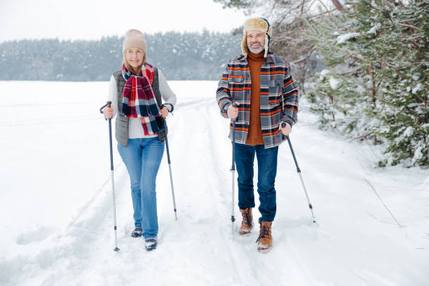 istock Couple on a walk with scandinavian sticks 2012386466