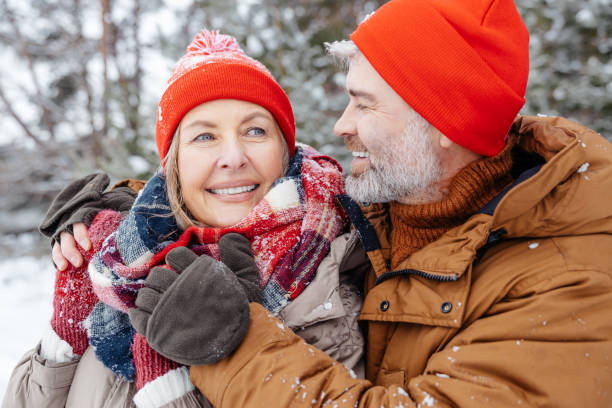 istock Mature couple looking close and romantic while spending time in a winter park 2012386541