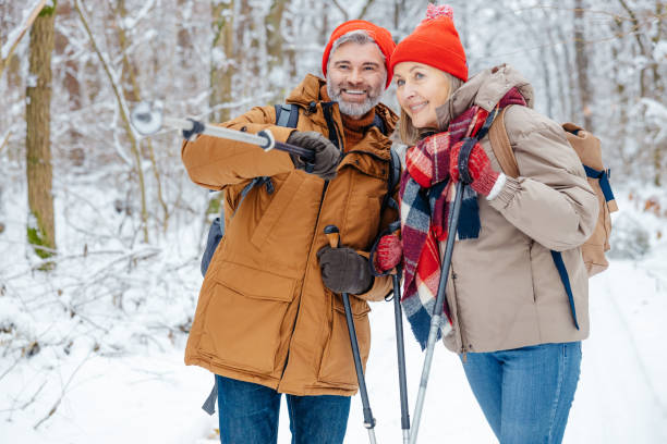 istock Mature couple having a walk with scandinavian sticks 2012386557