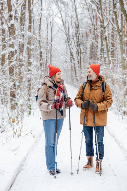 istock Mature couple having a walk with scandinavian sticks 2012386570