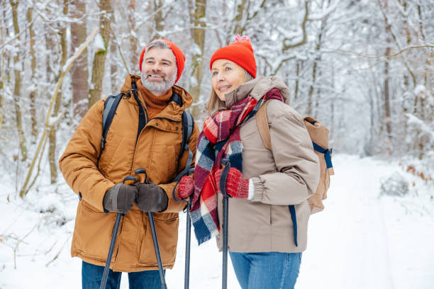 istock Mature couple having a walk with scandinavian sticks 2012386574