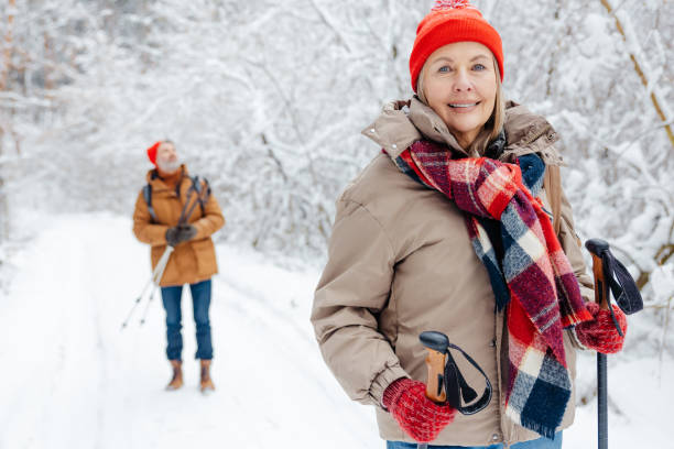 istock Mature couple feeling enjoyed while having a walk in a winter park 2012386586