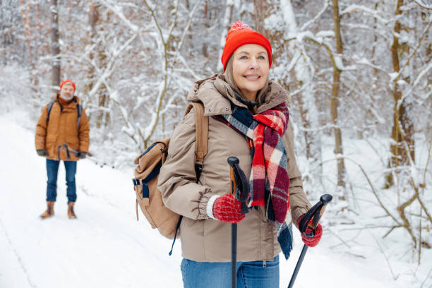 istock Mature couple feeling enjoyed while having a walk in a winter park 2012386589