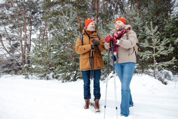 istock A mature couple spending good time together in a winter forest 2012386602