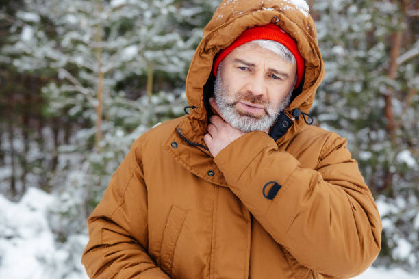 istock Man in a winter forest looking sick and unwell 2012386696