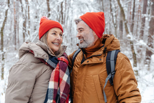 istock Happy mature couple in a snowy forest 2012386702