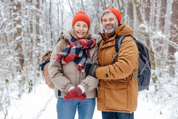 istock Happy mature couple in a snowy forest 2012386707