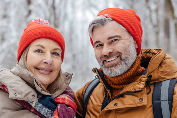 istock Happy mature couple in a snowy forest 2012386711