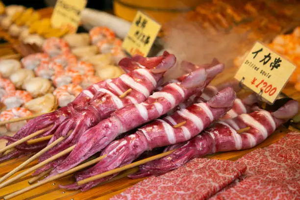 Photo of Squid at a food stall at the Tsukiji Outer Market in the city of Tokyo in Japan.