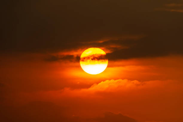 istock sunset with a dark appearance, round red sun 2012404651