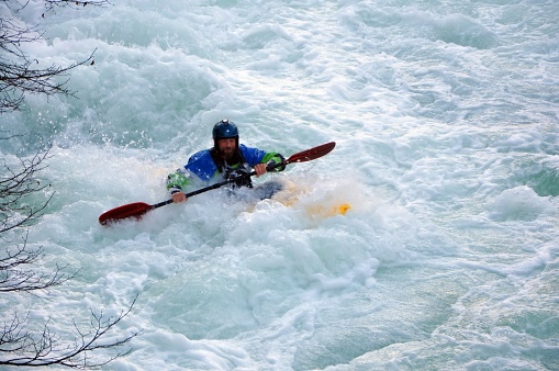Marinovo selo, Croatia November 11th 2023.  A kayaker negotiates his way through whitewater rapids on the Rjecina river Banner whitewater kayaking, extreme sport rafting.Guy in kayak sails rough river