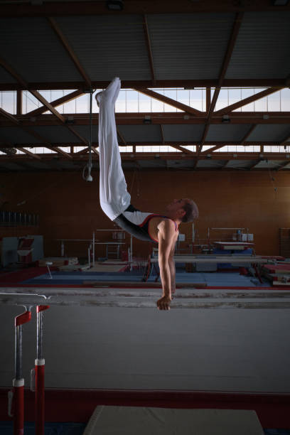 istock Young male gymnast doing exercises on the parallel apparatus. 2012415822