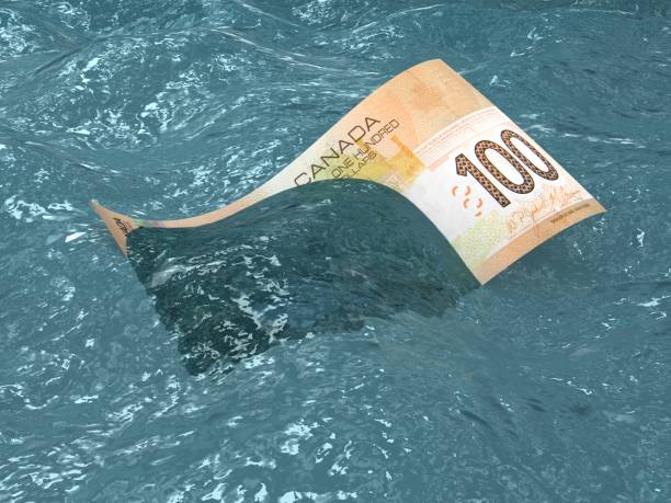 canadian falling money financial crisis recession drowning sea - storm sea business uncertainty foto e immagini stock