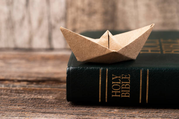 istock Holy Bible and paper boat 2012438154
