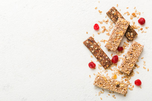istock Various granola bars on table background. Cereal granola bars. Superfood breakfast bars with oats, nuts and berries, close up. Superfood concept 2012438732